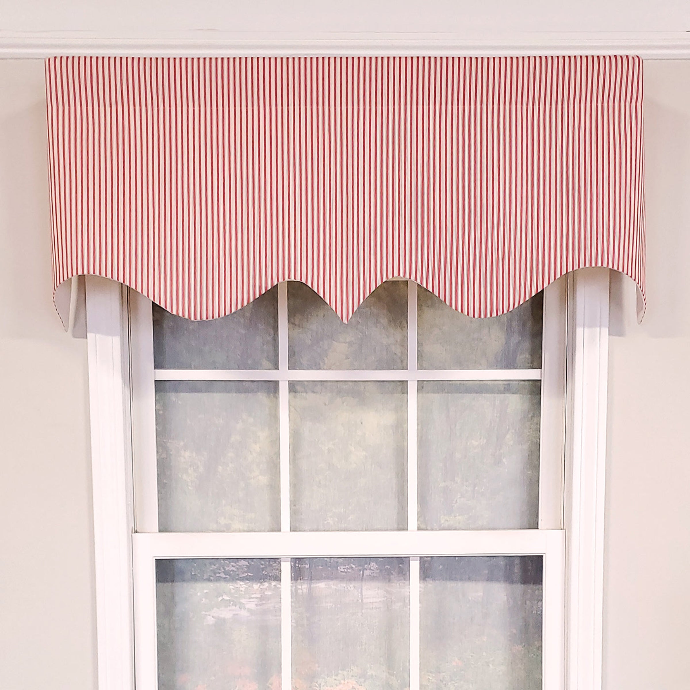 Window with a red striped valance against a white wall