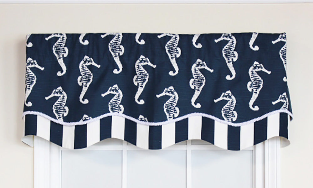 We love this window treatment that is a part of our coastal collection! Our Aquastrian Glory Valance touts a myriad of floating seahorses in white on a navy background. It is finished with a coordinating navy and white striped layer with a white gimp trim.