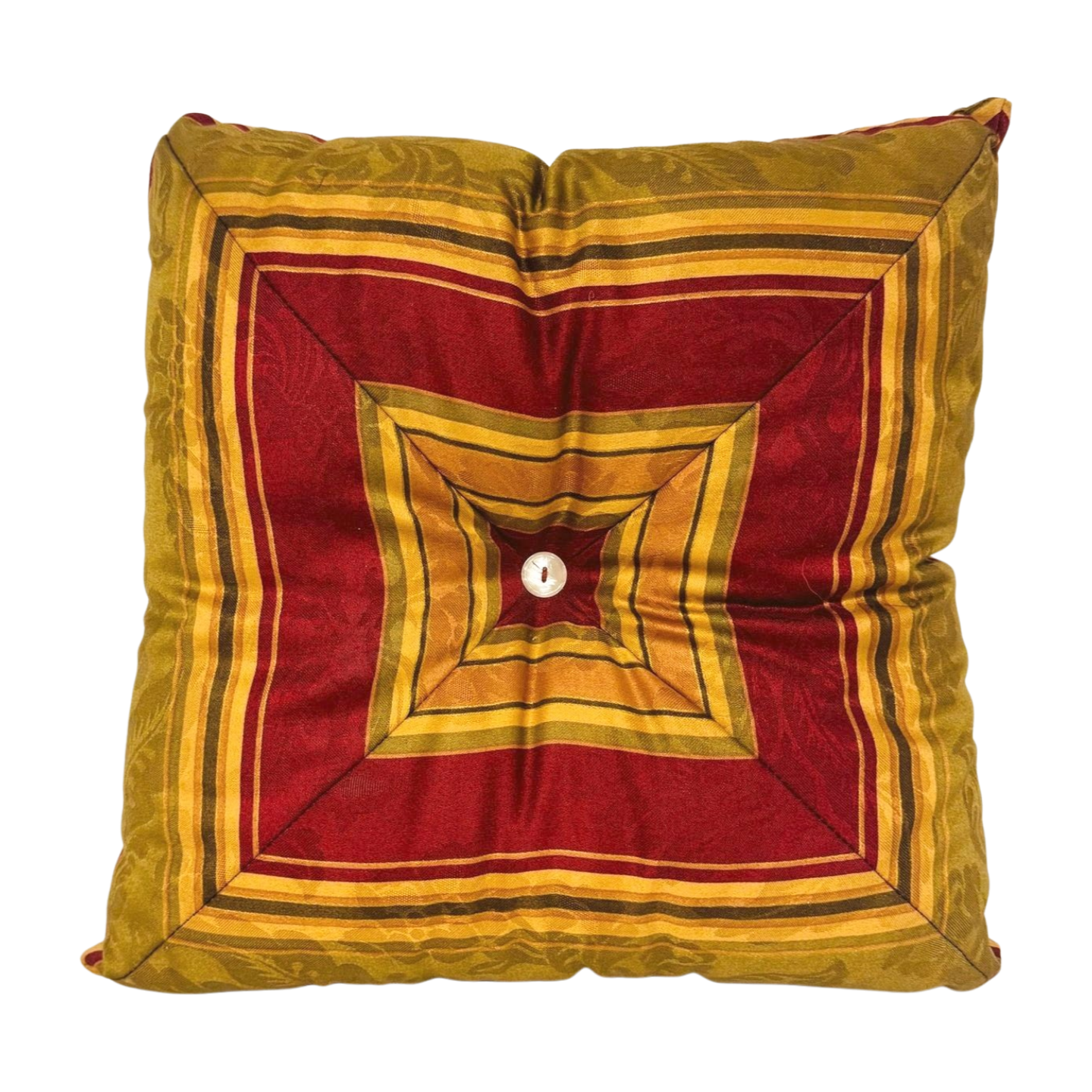 Decorative pillow with red and gold geometric pattern on a white background