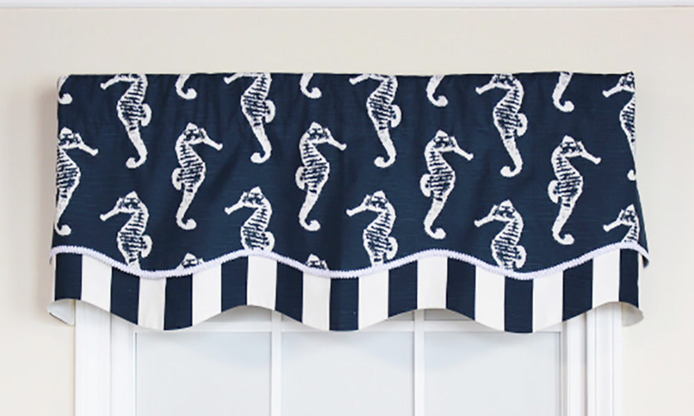 We love this window treatment that is a part of our coastal collection! Our Aquastrian Glory Valance touts a myriad of floating seahorses in white on a navy background. It is finished with a coordinating navy and white striped layer with a white gimp trim. 