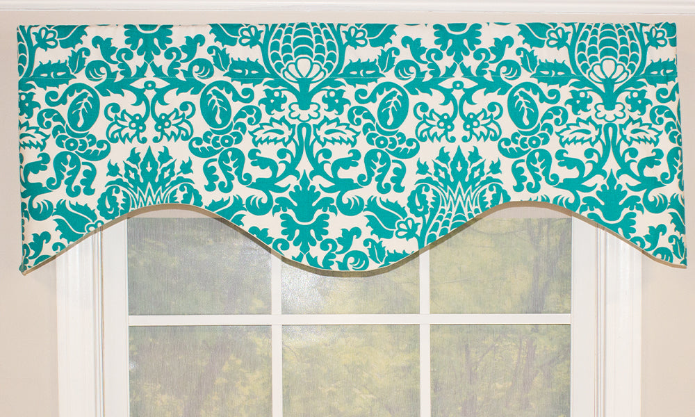Our Laura Loo Cornice Valance features a vibrant medallion pattern in aquamarine on an off-white background